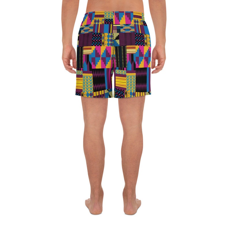 May include: A pair of colorful patterned shorts with a geometric design in shades of yellow, blue, pink, and black.