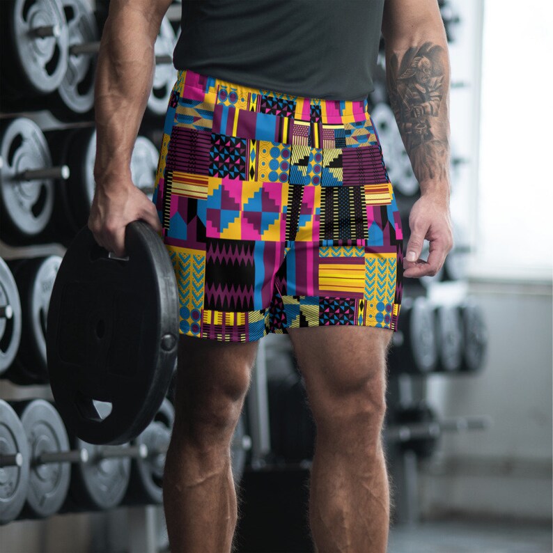 May include: A pair of athletic shorts with a colorful geometric pattern in shades of yellow, blue, pink, and black.