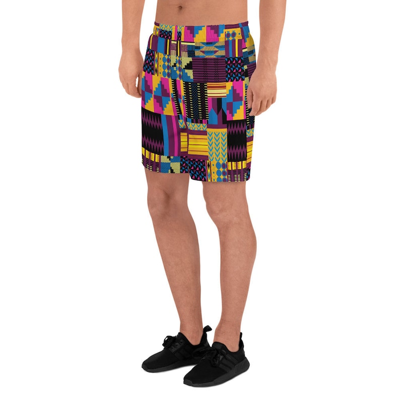 May include: A pair of athletic shorts with a colorful geometric pattern in shades of yellow, pink, blue, and black. The shorts are made of a lightweight, breathable fabric and are perfect for working out or running errands.