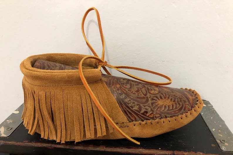 Inspired by a fusion of Native American and western cultures, these handcrafted moccasins are made completely of leather