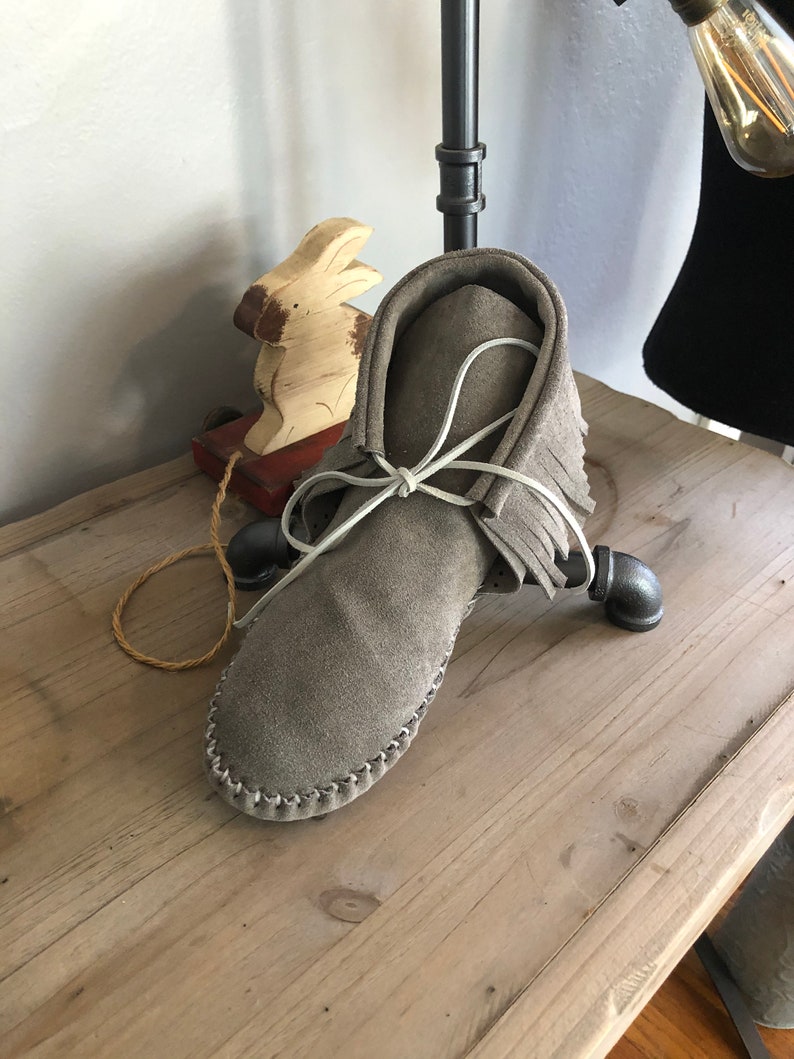 Inspired by a fusion of Native American and western cultures, these handcrafted moccasins are made completely of leather image 1
