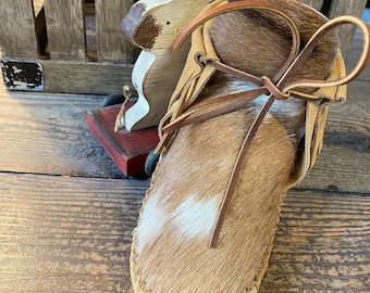 Inspired by a fusion of Native American and western cultures, these handcrafted moccasins are made completely of leather