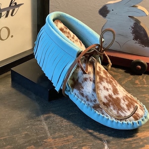 Inspired by a fusion of Native American and western cultures, these handcrafted moccasins are made completely of leather