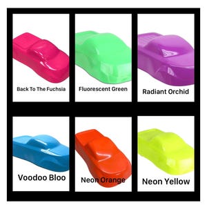 May include: Six glossy car-shaped paint samples in various colors. The colors are labeled as Back To The Fuchsia, Fluorescent Green, Radiant Orchid, Voodoo Bloo, Neon Orange, and Neon Yellow. Each sample features a smooth, reflective finish.