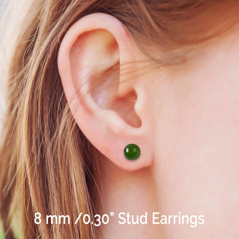 May include: A pair of green stud earrings with a round shape. The earrings are 8 mm / 0.30" in diameter.