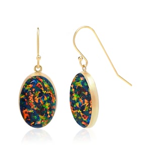 May include: A pair of gold-colored drop earrings. Each earring features an oval-shaped, iridescent stone with a mix of blue, green, and orange hues. The earrings have a simple hook design for pierced ears.