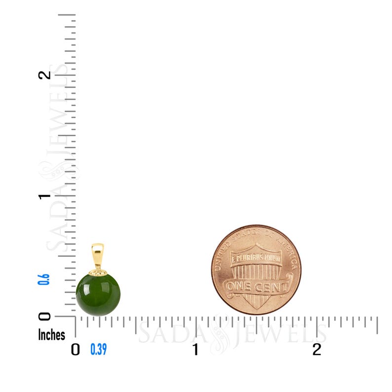 May include: A green jade pendant with a gold bail. The pendant is about 0.39 inches in diameter. A US penny is shown for size comparison.