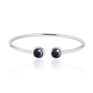 May include: A silver bangle bracelet with two black pearl accents.