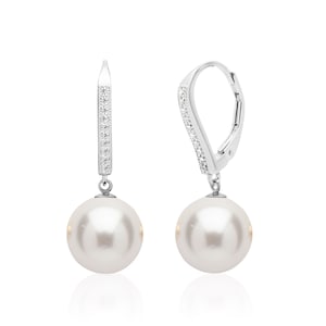May include: A pair of silver dangle earrings with a white pearl drop and a row of clear cubic zirconia stones on the leverback.