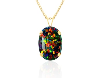 May include: A gold chain necklace featuring an oval-shaped black opal pendant. The gemstone displays a vibrant play of color with flecks of red, green, and yellow against a dark background, secured in a four-prong yellow gold setting.