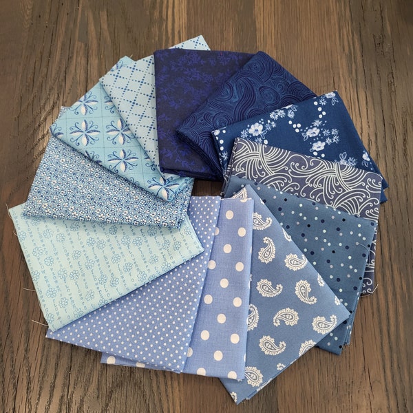 Blue birds fat quarters fabric bundle of 12 assorted quality cotton prints.  Mix of sky blue, periwinkle, medium and deep ocean blue. Fun