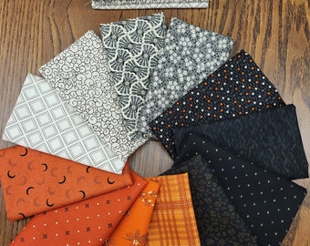 Hallows Eve Civil war fat quarters bundle. a mix of various Quality cotton prints.  12 fat quarters.  black, burnt orange, tan and more.