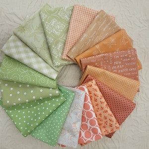 May include: A collection of 14 fabric squares in various patterns and colors, including green, orange, and white. The fabrics feature geometric patterns, floral designs, and text.