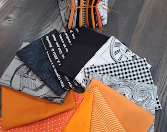 Halloween fun fat quarters fabric bundle of 12 assorted prints. Quality cotton.  Black, bright orange and gray. Swirls, words, checks plus