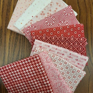 39. Sweet red and pink  fat quarters fabric bundle of 10 quality cottons. Perfect for the season. Cheery red and adorable pink combination
