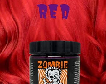 May include: A jar of Zombie Snot hair dye with a black lid. The label features a zombie illustration and the text "Zombie Snot Hair Dye". The background is red with the text "666 RED". The container is 6 oz.