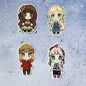 May include: Four colorful cartoon character stickers. The stickers feature a girl with brown hair and a red dress, a girl with blonde hair and a blue dress, a girl with blonde hair and a red jacket, and a girl with pink hair and a blue and yellow outfit.