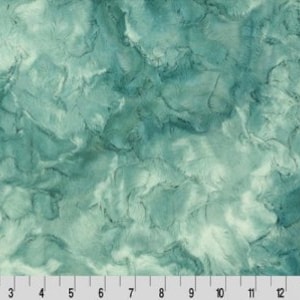 May include: Abstract teal and white fabric with a marbled, swirled pattern. The fabric has a soft, fuzzy texture.