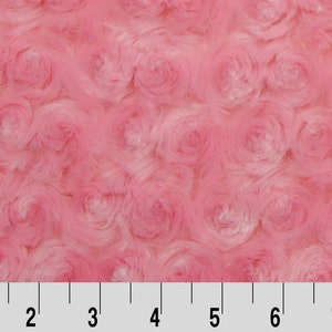 May include: Pink fabric with a swirl pattern. The fabric is soft and fuzzy, and it looks like it would be perfect for a baby blanket or a throw.
