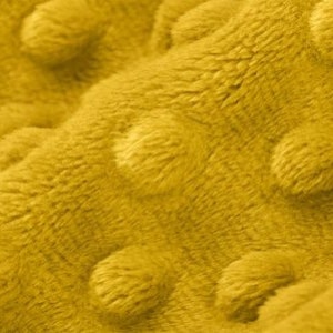 May include: Close-up of a yellow textured fabric with a raised dot pattern. The fabric is soft and plush.