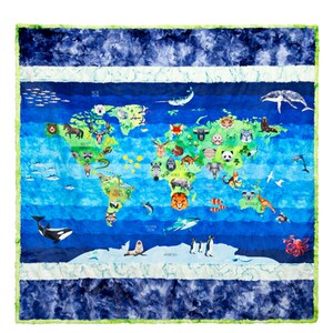 May include: A blue and green world map blanket featuring illustrations of various animals. The blanket has a blue and white border with a green trim. The map includes illustrations of whales, penguins, and other animals.