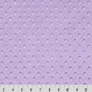May include: A close-up of a lavender fabric with a textured polka dot pattern.