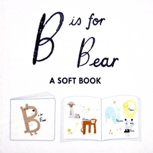 May include: A soft book for babies with the letter B and the word "Bear" on the cover. The book is open to show illustrations of a bear, lamb, monkey, narwhal, and panda.