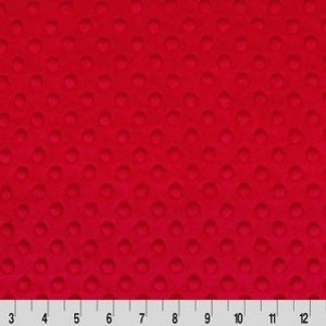 May include: Red fabric with a textured pattern of small circles. The fabric is a solid color with a subtle sheen.