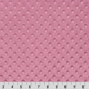 May include: A close-up of a pink fabric with a textured pattern of small raised dots.