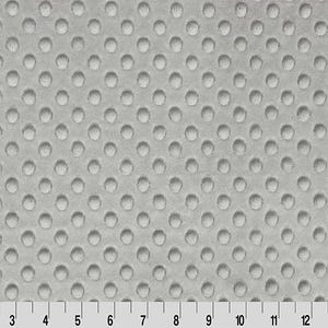 May include: A light gray, textured fabric with a repeating pattern of small, raised circles. A ruler with inch markings is along the bottom edge, showing measurements up to 15 inches.