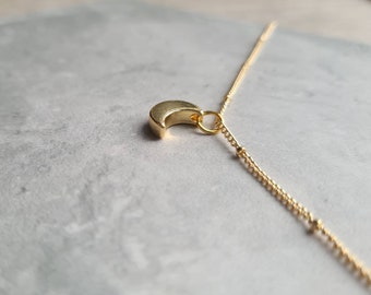 Crescent moon charm on a gold plated satellite chain. Dainty moon charm necklace. 16, 18, 20, 22 or 24 inch chain.