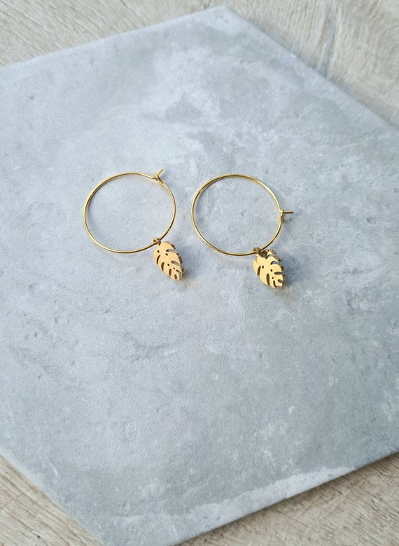 Monstera leaf charm on gold hoop earrings. 25mm wide.