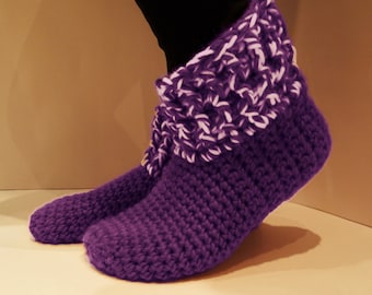 May include: Purple crocheted slippers with a white and purple trim around the top of the slipper.