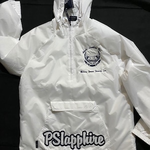 May include: White hooded jacket with a zipper closure and a large pocket on the front. The jacket has a navy blue logo with the text "Alpha Lambda Phi" and "Willingness, Service, Serenity, Inc." The bottom of the jacket has a navy blue patch with the text "PSlapphire".