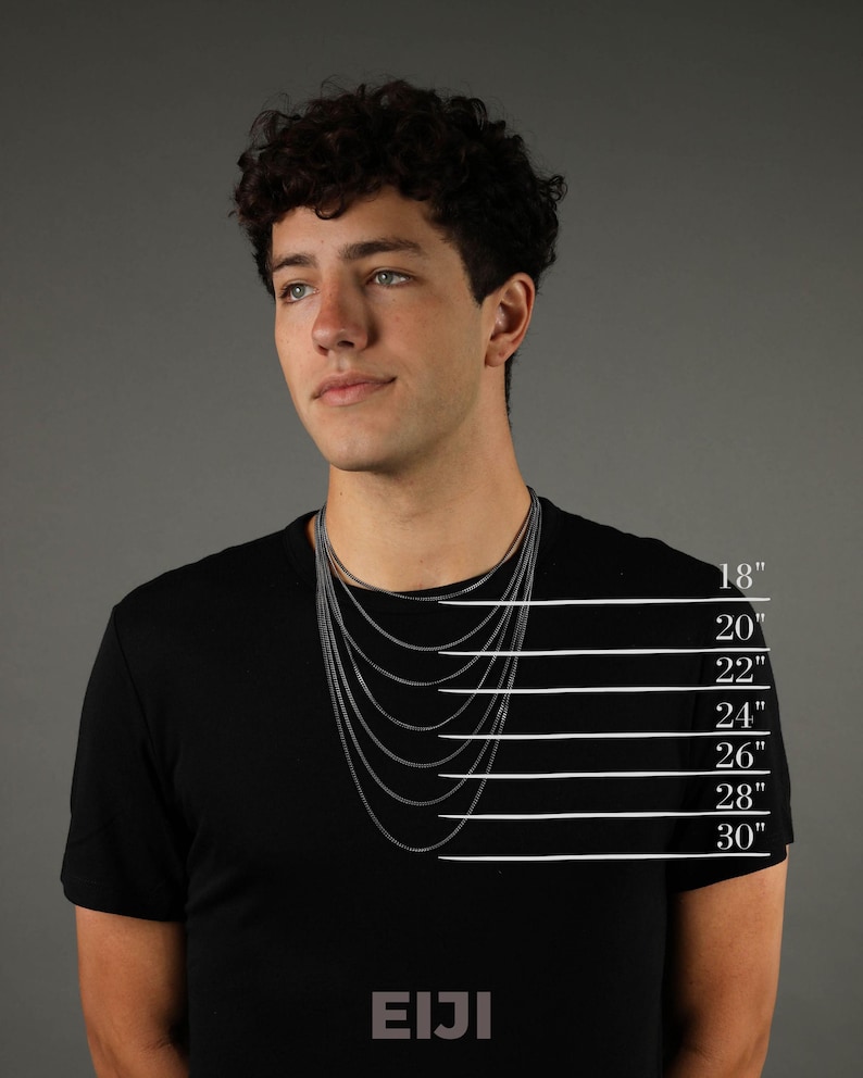 May include: A model wearing a black t-shirt with a silver chain necklace. The image shows different chain lengths from 18 inches to 30 inches. The text "EIJI" is printed on the bottom of the image.