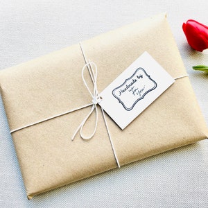 Clever wrapped offering with artisan written roaminate tag and a rose next to it.