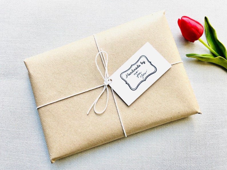 Clever wrapped offering with artisan written roaminate tag and a rose next to it.