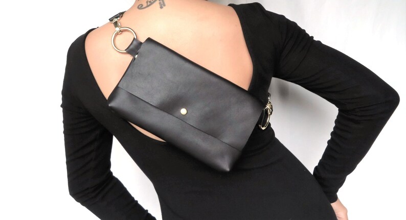 Real Little backpack on a gals upper back with flap and LBD (Little Black Dress)