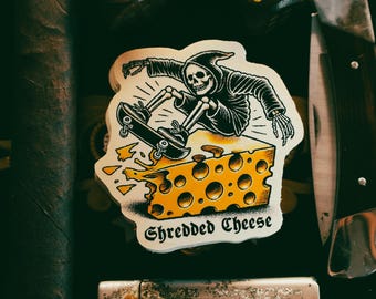 Shredded Cheese Skeleton Skateboarding Sticker - Vintage Tattoo-Style Die Cut Premium Sticker