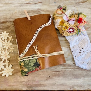 Rustic leather journal with fabric. Junk journal, leather art journal. Vintage antique, old recycled materials. Neutral color, mixed papers