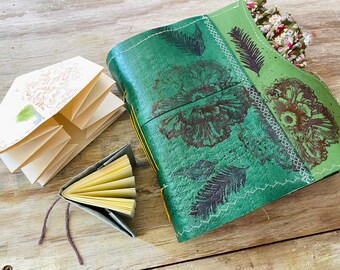 Green leather journal, different papers, fold, pockets, hiding places. Mixed media, writing, visual artist book. Empty handmade junk journal
