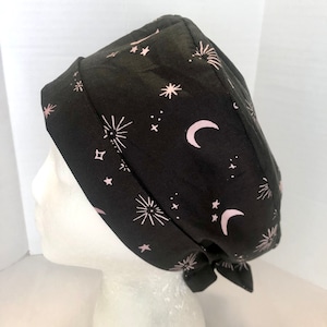 May include: Black scrub hat with a pink and white moon and star pattern.