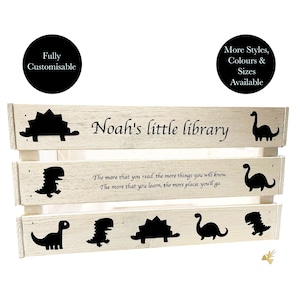 May include: A distressed white wooden bookshelf with black dinosaur silhouettes and the text "Noah's little library." The shelf has the quote, "The more that you read the more things you will know. The more that you learn, the more places you'll go."