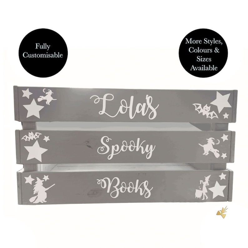 May include: A gray wooden crate with three shelves, featuring white text and Halloween-themed illustrations. The top shelf reads "Lola's", the middle "Spooky", and the bottom "Books". White stars, bats, and witch silhouettes decorate the crate.