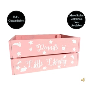 May include: Pink wooden crate with white stars, bunnies, and the text "Penny's Little Library." The crate is fully customizable and available in more styles, colors, and sizes. A decorative storage solution for a child's room.