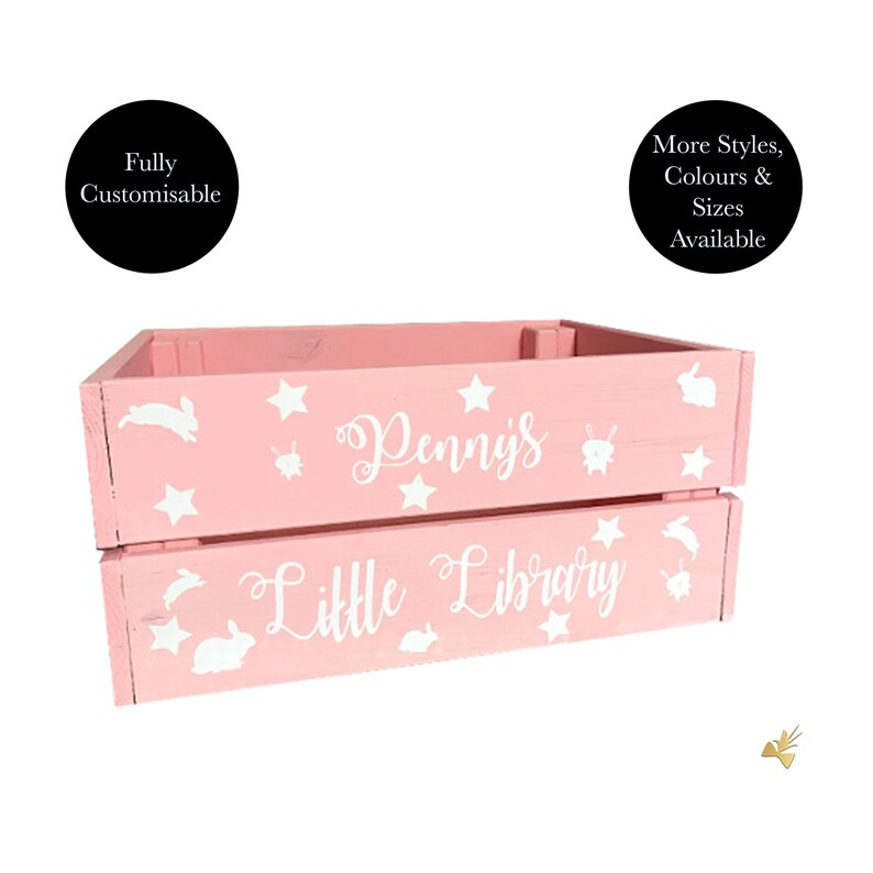 May include: Pink wooden crate with white stars, bunnies, and the text "Penny's Little Library." The crate is fully customizable and available in more styles, colors, and sizes. A decorative storage solution for a child's room.