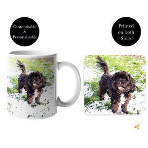 May include: A white ceramic mug with a black and white dog image printed on it. The dog is standing in a snowy grassy area. The mug is customisable and personalisable. The image is also printed on a matching coaster.