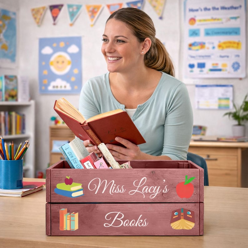May include: A wooden crate with the text "Miss Lacy's Books" and illustrations of books and an apple. The crate is filled with books and other items. The crate is a reddish-brown color.