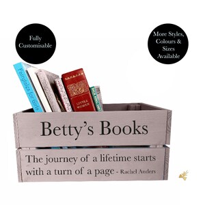 May include: A gray wooden crate labeled "Betty's Books" filled with books, including "Fairytales for Girls" and "Little Women." The crate has the quote "The journey of a lifetime starts with a turn of a page - Rachel Anders."