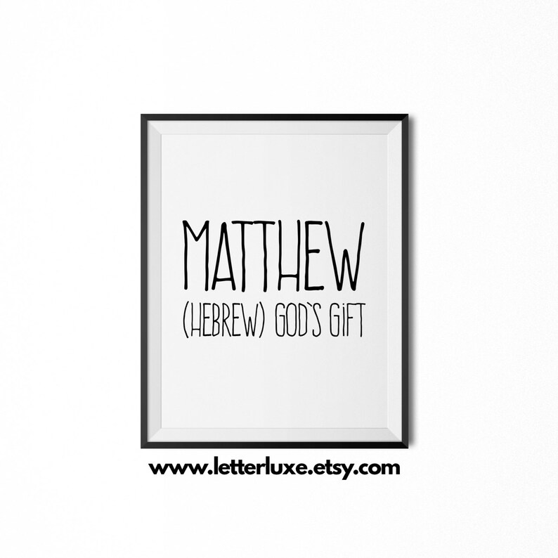 May include: A framed print featuring the name "MATTHEW" in black, bold lettering. Beneath the name, the text reads "(HEBREW) GOD'S GIFT". The print is in a black frame, with the website address "www.letterluxe.etsy.com" at the bottom.